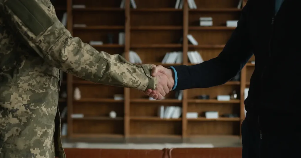 Servicemember shaking hands with agent