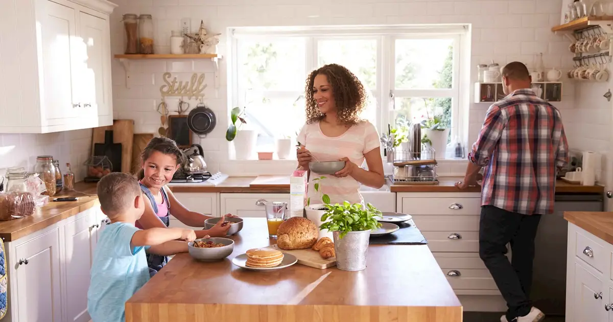 Family enjoying breakfast in a bright, cozy kitchen with natural light.