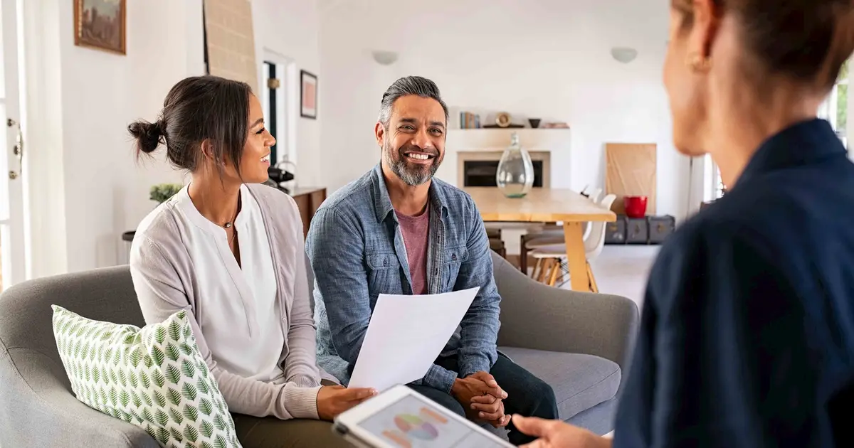 Real estate agent advising a couple.