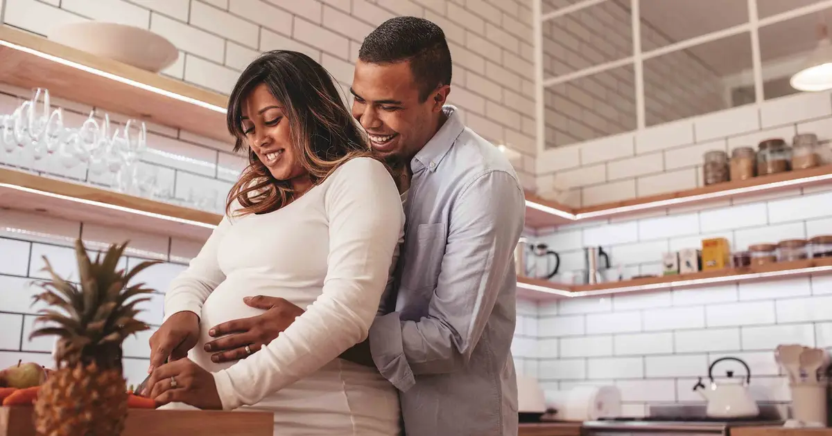 Smiling couple in kitchen.