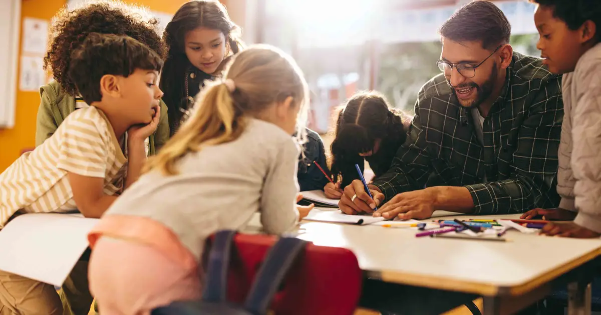 Teacher assisting students with an activity.