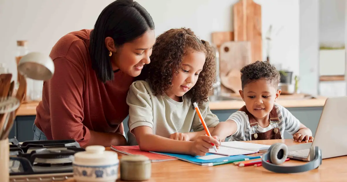 Mother helping children with homework.