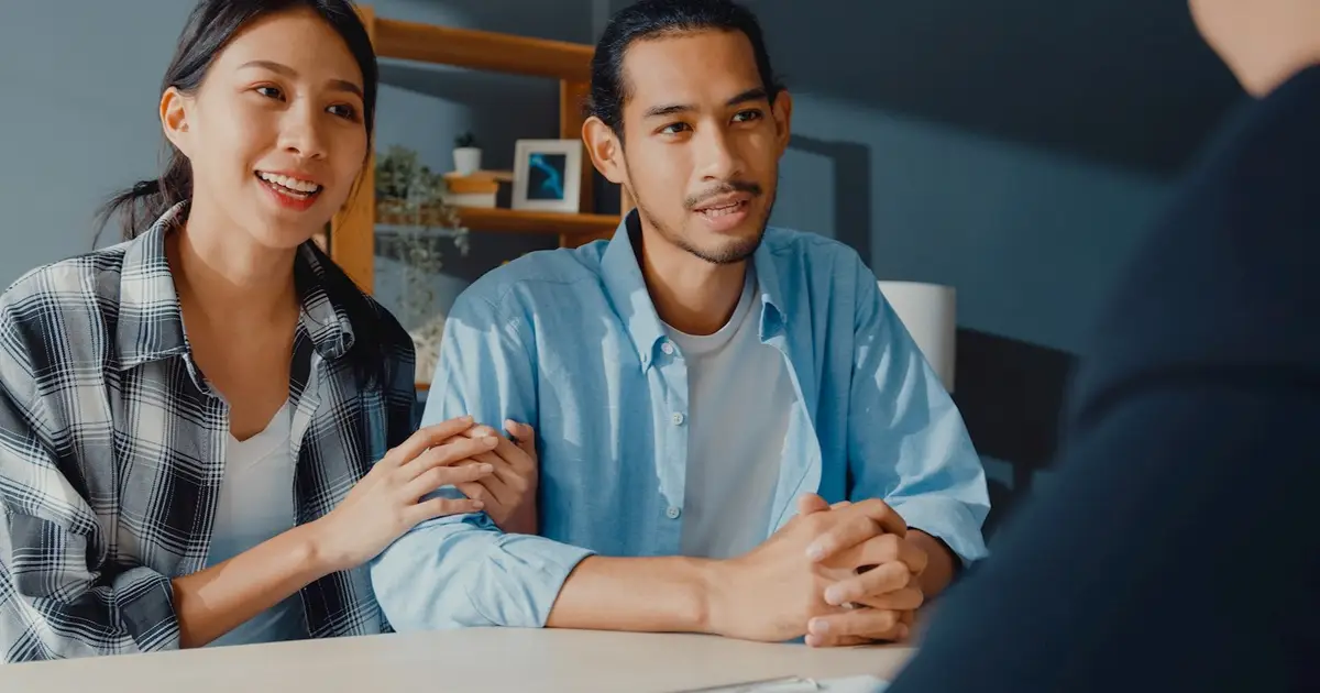 Couple meeting with professional, smiling and engaged.