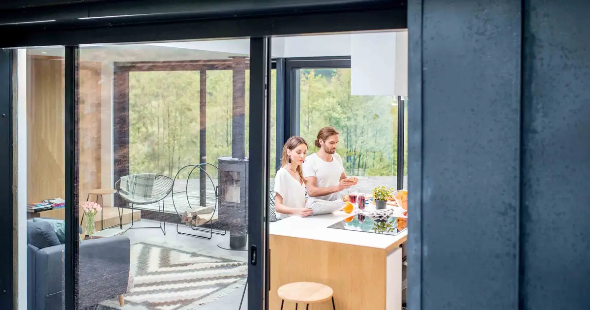Couple cooking in bright kitchen.