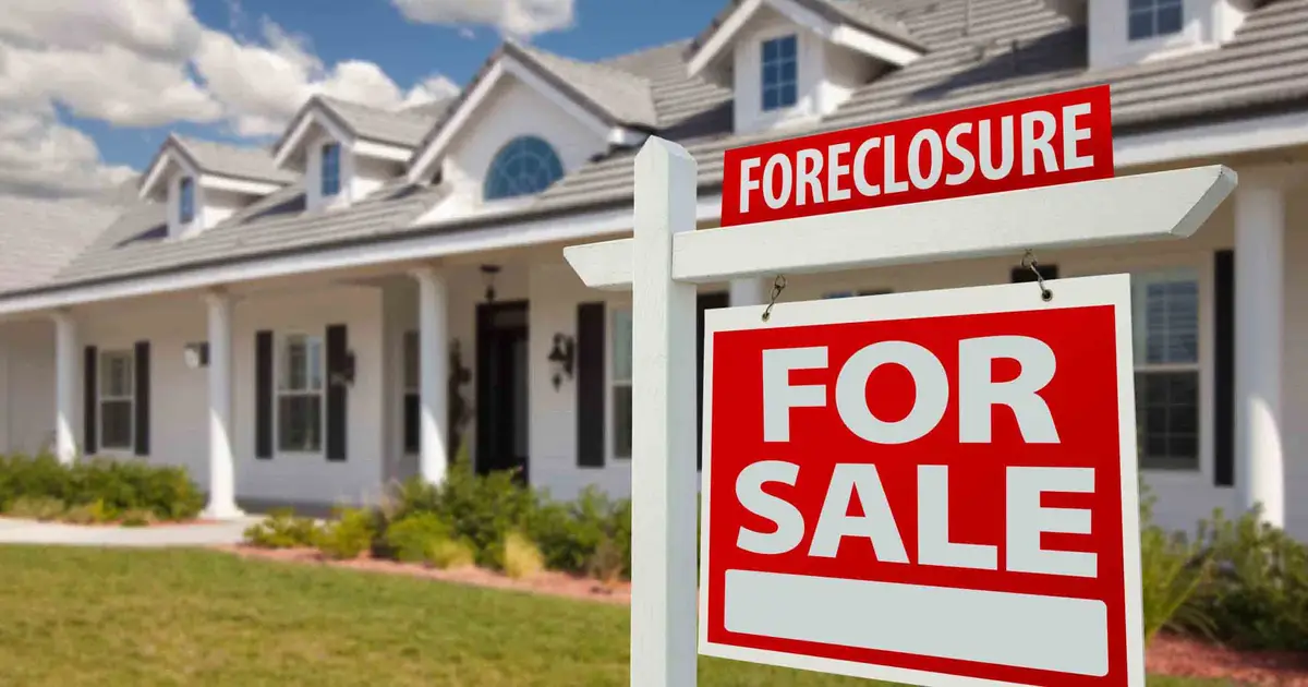 Foreclosure' sign in front of house.