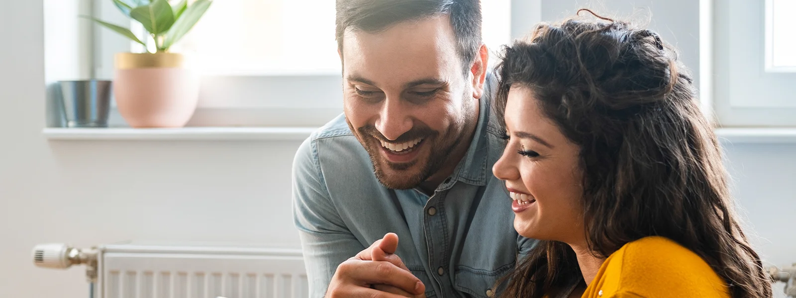 Couple sitting together looking at a phone.
