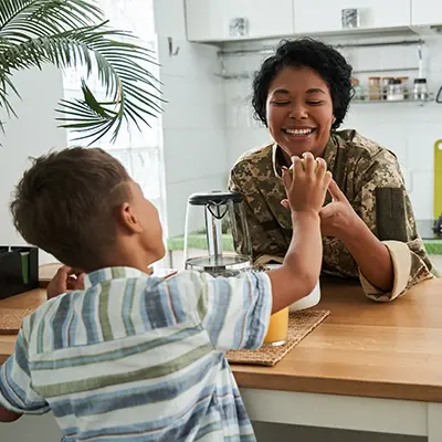 Military mother and her son in the kitchen.