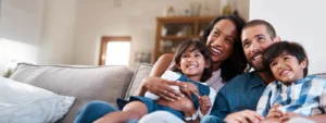 Family sitting together on a couch.