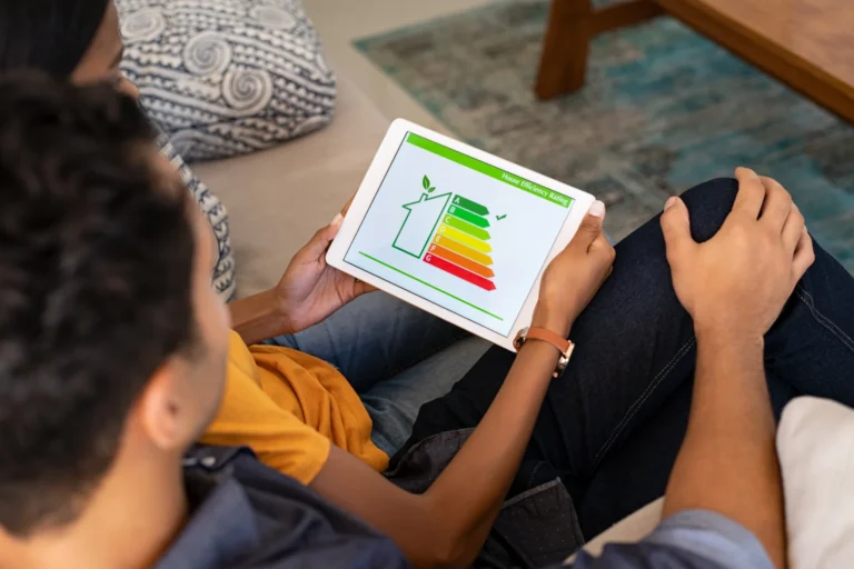 Couple reviews home energy efficiency chart on tablet together.