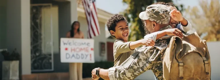 A soldier hugging his child.