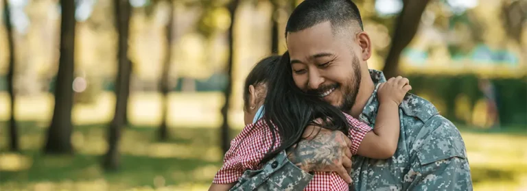 A soldier hugging his daughter.