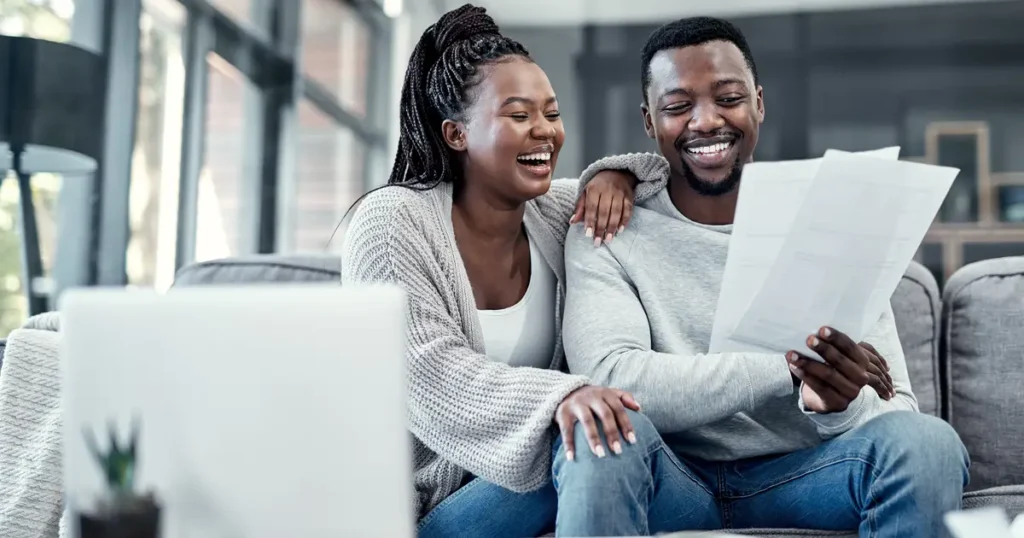 Smiling couple reviewing documents