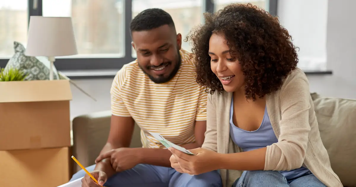 Smiling couple reviewing finances