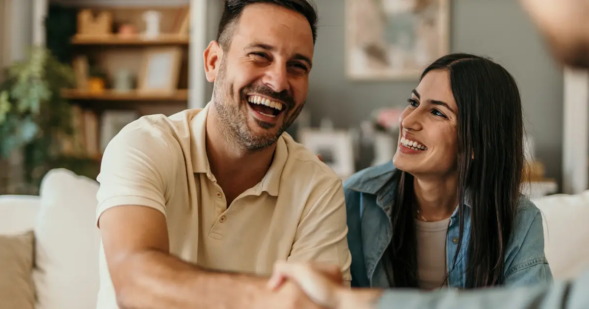 Smiling man shaking hands with agent