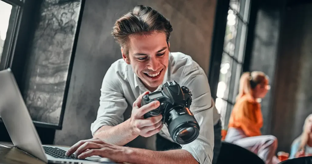 Smiling man holding camera