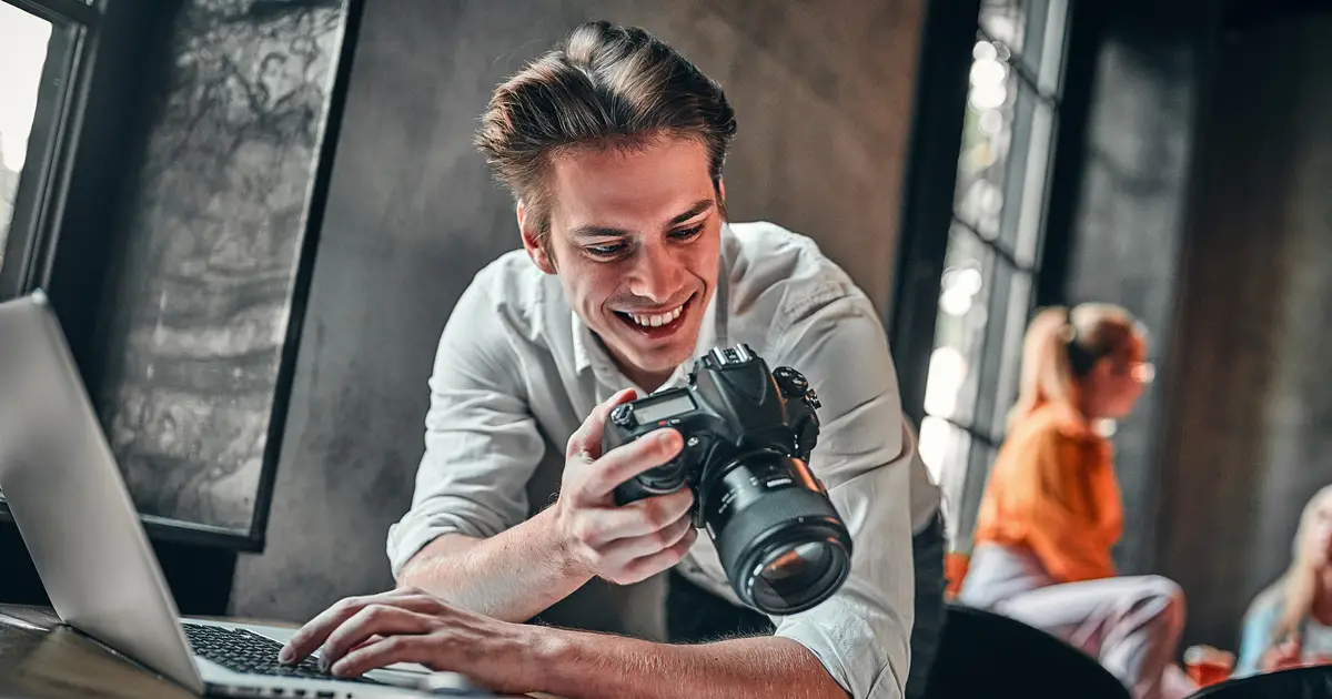 Smiling man holding camera