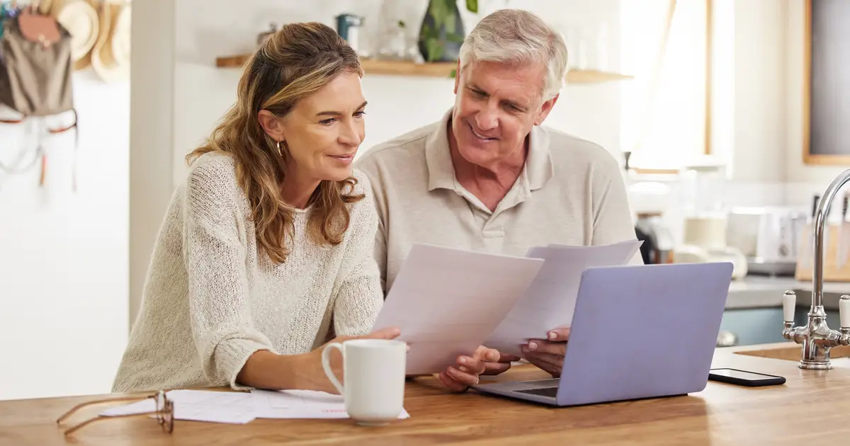 Happy smiling retired couple with laptop
